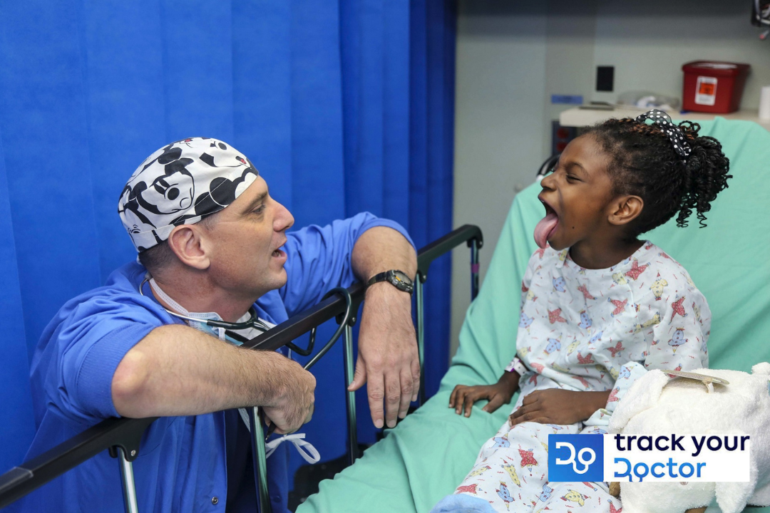 A medical exam showing a doctor in blue scrubs and a little girl in a hospital bed. #improve online reputation